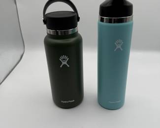 Set of two Hydro Flask water bottles in different colors. Includes one olive green and one light blue model. See pictures for more details. New Condition. 
