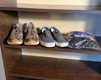 Men's size 8.5 shoes. Includes a pair of Nike athletic shoes in a blend of gray and olive green with white accents and an orange outsole, and a pair of gray and black checkerboard slip-on Vans shoes with white soles and lining. Also, a pack of ten Hanes Cool Comfort no-show socks in black.