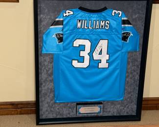 Framed autographed Carolina Panthers jersey by DeAngelo Williams, number 34. Features a vibrant blue color, perfect for collectors and fans. See pictures for more details.