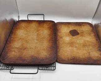 Set of three baking sheets from Pampered Chef!  Two rectangular and one circular. Rectangular stones are seasoned and ready for use. The edges are slightly rounded, and they rest on a black metal cooling rack. Cleaning scraper included. 
