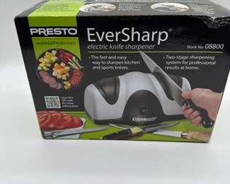 Brand: Presto. Model: EverSharp. Color: Black and silver. Features: Electric knife sharpener with two-stage sharpening system. Includes sapphire sharpening wheels for precise edge. Text on box: 'The fast and easy way to sharpen kitchen and sports knives.' Stock number: 08800. Household use only.
