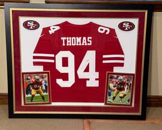 Framed autographed jersey of Solomon Thomas, #94, from the San Francisco 49ers. Includes two framed photographs. Perfect for collectors or fans of the team.
