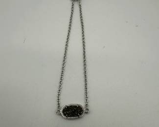 Beautiful Kendra Scott adjustable bracelet featuring a reversible charm, crystals on one side and filagree on the other. Very good condition.