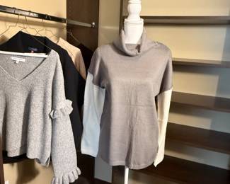 This lot features two women's sweaters: a gray ruffled sleeve sweater and a cowl neck sweater in neutral tones. Perfect for layering in the fall and winter seasons.