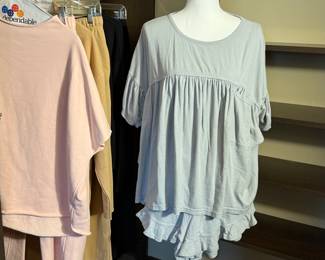 Casual loungewear collection including shorts and a blousy top from Free People Beach (FP Beach), a black knit sweater set with pants and a cardigan from Anthropologie Daily Practice, a set in pink with cropped sweats, a tan collared set with cropped sweats. 