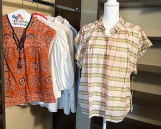 Assorted Women's Tops including a vibrant orange patterned blouse, classic white shirt, and a pastel plaid shirt. Perfect for casual wear or layering. See pictures for more details