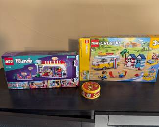 Description:
Includes LEGO Friends set 41728 featuring bright colors and playful design, LEGO Creator 3-in-1 set 31113 with a colorful camper van and beach houses, and a red and yellow circular game container labeled 'Spot it!' with an eye-catching logo.

