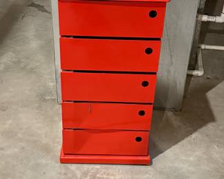 A red metal storage cabinet featuring five drawers. Each drawer has a circular handle hole. The top is smooth and flat, with visible screws securing it. The brand logo 'DOTTUS' is displayed on the top front.