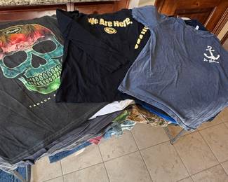 Assorted Graphic Tees Lot featuring a skull design shirt, 'We Are Here' graphic, and an anchor logo tee. Various styles for casual wear. See pictures for more details.