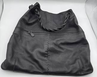 Black leather handbag with braided handles. Features a zippered compartment. Ideal for everyday use or casual outings.