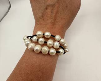 Beautiful freshwater pearl bracelet featuring three strand and a button closure. Bracelet is in very good condition and is a fun statement piece. Also included is a fun beaded bracelet with multi color metal beads.
