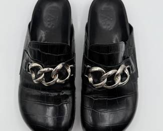 Lot #28 LAST Black Leather Mules with Bold Chain Detail, Women's Size 40. Black leather mules with embossed alligator texture, featuring a bold silver chain detail on the upper. The shoes have a slip-on design and a sturdy rubber sole.