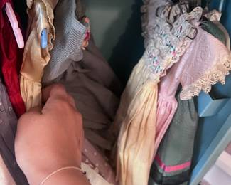 Toy closet filled with antique doll dresses