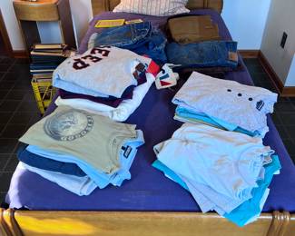 Bed full of vintage menswear; tees, crewnecks, jeans... 