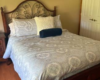 Queen bed with mattress and box spring , bed has wrought iron work , Bedding is also for sale 