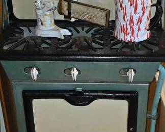 Antique 1920's - 30's Cast Iron and Porcelain Stove in a mint green color. Excellent condition/ Yes that is vaseline glass (uranium) on top. There are very cool scales throughout the house.  