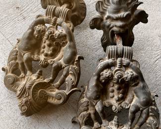 These are Fabulous !! I’m using that word twice, because they are FABULOUS ! 
Very heavy IRON Antique French Door Pulls, w/Cherubs , Scrolls & Grotesque Figures…
You might need a castle with high doors to pull these off …Rare find  $$