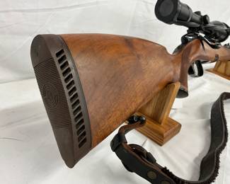 polished wood stock with dark checkered grip panel