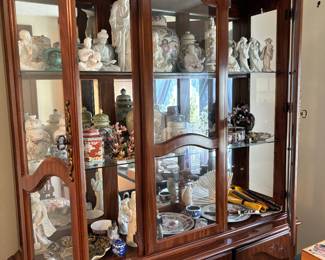 glass cabinet, lots of Asian style dishes, decorations and figures