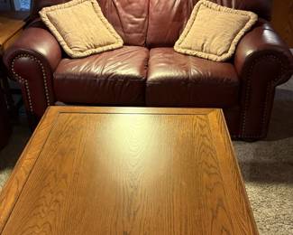 Leather loveseat and coffee table with drawers (sold separately).