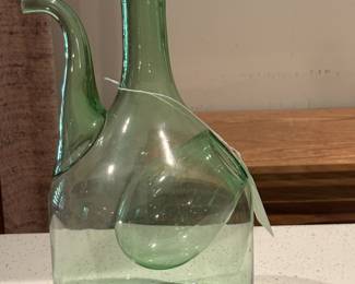 Unique green glass pitcher designed with separate ice compartment to keep liquid cold without watering down the contents of the pitcher!