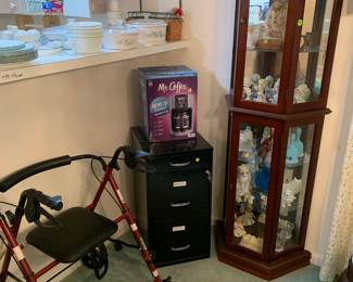 Curio cabinet with collectibles, walker, filing cabinet, and corelle set