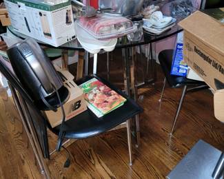 Glass topped table with chrome legs on table and chairs