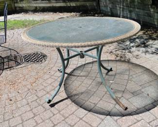Large round glass topped table, trimmed in wicker