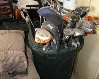 A large trashcan full of clubs
