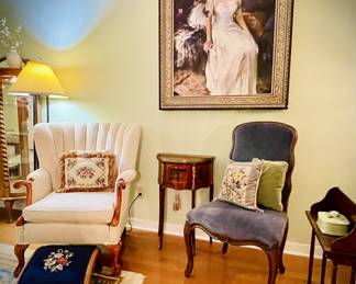 Formal Living Room-
- Antique 1920s French Demi-lune Table
- Large Original Painting
- Blue Velvet Sitting chair
- White Wingback chair & embroidered foot rest