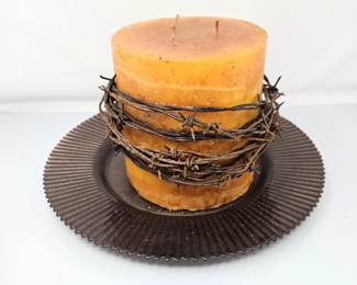 Rustic Orange Candle on Dark Glass Plate with Barbed Wire Wrap Candle is 6" x 7"