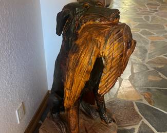 Hand carved wooden dog with bird