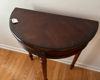 C56 - $35. Small Demilune Table. Measures 23.75" wide x 11.5" deep x 30" tall.