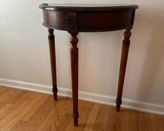 C56 - $35. Small Demilune Table. Measures 23.75" wide x 11.5" deep x 30" tall.