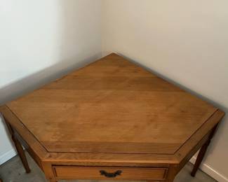 C100 - $40. Harvest Oak Corner Table. Measures 49" across at the widest point. Each corner comes out from the wall 35" x 25" tall.