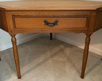 C100 - $40. Harvest Oak Corner Table. Measures 49" across at the widest point. Each corner comes out from the wall 35" x 25" tall.