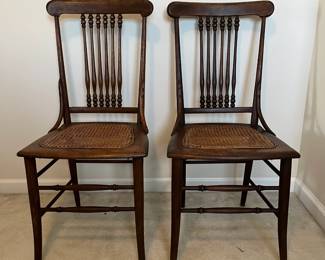 C102 - $50 PAIR of Antique Spindle Chairs. Single Caned - no holes but aged caning. Measures 16.5" wide x 17" floor to seat x 35.5" tall.
