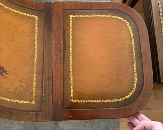 C58 - $50. Mahogany Half Circle Leather Top Coffee Table. Measures 4' x 14" deep x 16.5" tall. Each leaf adds 11.25" to each end if extended.