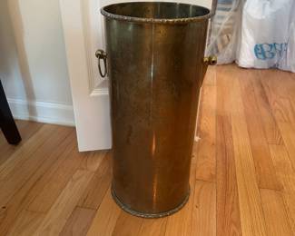 C62 - $30. Brass Umbrella Stand (could also be trash can). Measures 8.5" wide x 18" tall. Missing one handle ring.