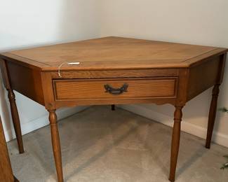 C100 - $40. Harvest Oak Corner Table. Measures 49" across at the widest point. Each corner comes out from the wall 35" x 25" tall.