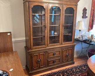 C34 - $75. Thomasville China Cabinet - Lighted. Moves in 2 pieces. Assembled it measures 58" wide x 16" deep x 75.5" tall. Has glass shelves inside (not adjustable).