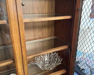 C34 - $75. Thomasville China Cabinet - Lighted. Moves in 2 pieces. Assembled it measures 58" wide x 16" deep x 75.5" tall. Has glass shelves inside (not adjustable).
