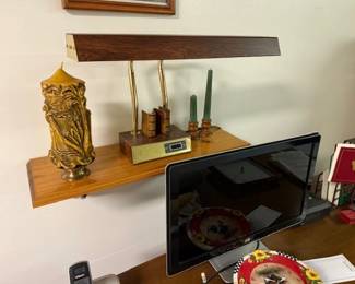 Candle. Desk lamp. Monitor. 