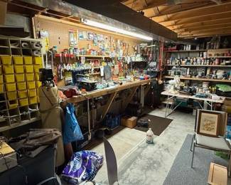 Nice work area in the basement. Tools. HOTSY filter tank. Storage bins. Hardware/supplies. Paint. Jigsaw. Sander. Vise.
