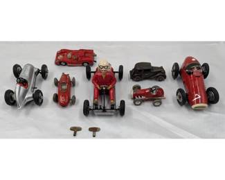 Lot Of 7 Vintage Toy Cars, Six German Shuco Wind-Up Cars And One Cast Iron Austin Sedan
