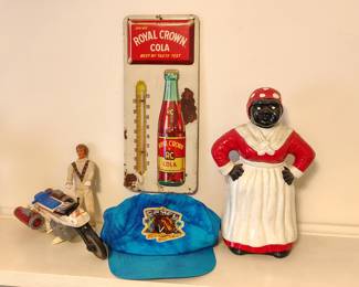 This picture sums up the sale. We have vintage clothes, vintage advertising signs , vintage toys like the evil kenevil toy and a cast iron mammy.
