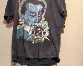 Vintage rock band shirt (Tesla) and vintage "nuclear wash" brand blue jeans.