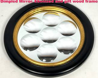Lot 2 Fornasetti style Framed Round Dimpled Mirror. Ebonized and gilt wood frame