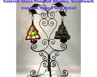 Lot 772 Antique Wrought Iron Lamp. Two Colored Glass Pendant Shades. Scrollwork iron has figural leaf detail