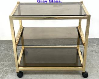 Lot 1007 Gold Tone Brass Bar Cart with Gray Glass. 